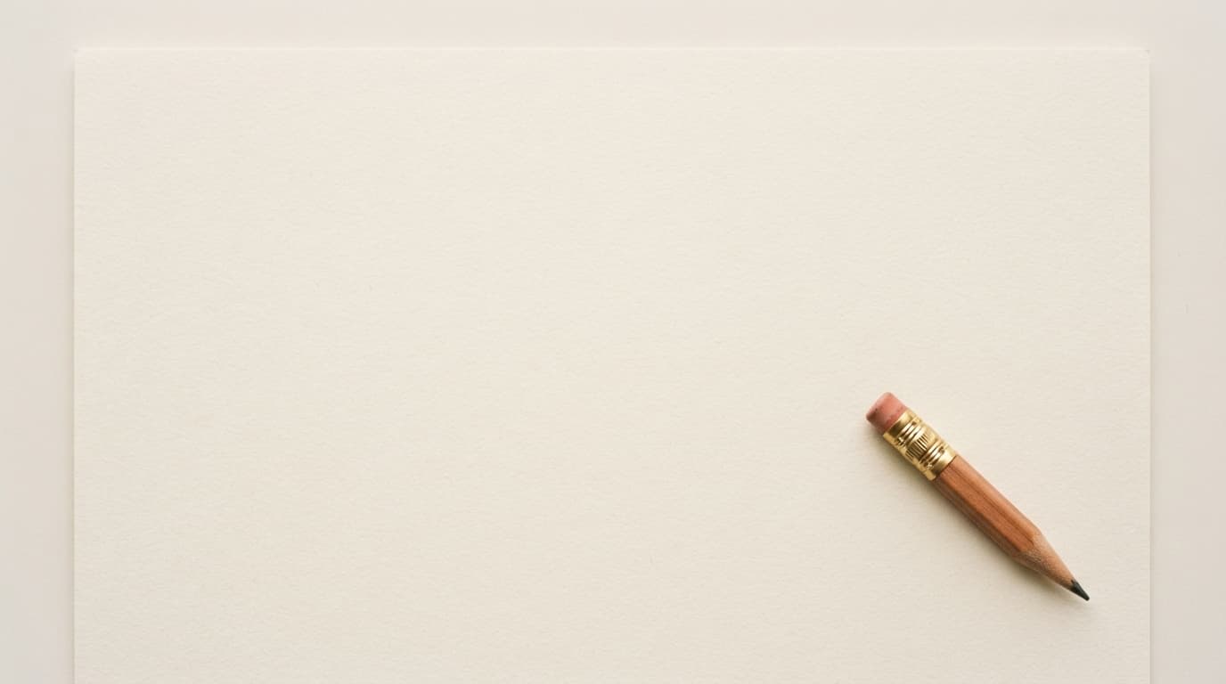 A large expanse of empty warm-white paper with a single brass-ferruled drafting pencil at the lower right, soft diffuse light from above